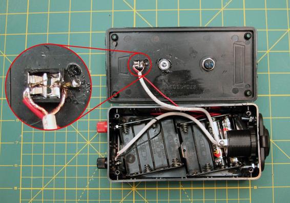 Connect the negative tab on the cigarette lighter socket and the black wire from the battery pack to the black terminal on the opposite side of the box from the cigarette lighter socket. Connect the positive terminal of the cigarette lighter socket and the positive lead from the battery pack to the two connectors sticking up from the phono jack on the lid of the launch controller.