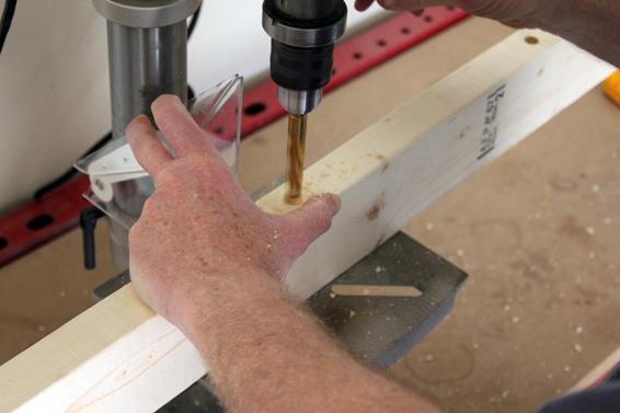 Drill four 1/2” holes all the way through the wood at the locations of each launch rod.