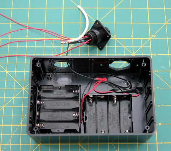 Form a bundle of the black wire from the battery holder, the four black wires from the 9-pin connector, and a 4” piece of 18-gauge wire. Solder these together.