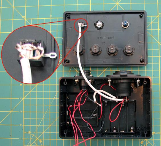 Solder the 18-gauge wire from the 9-pin connector to the negative terminal of the cigarette lighter socket. Use an 8” piece of 18-gauge wire to connect the top two terminals of the phono jack to the positive terminal of the cigarette lighter socket. Solder the red lead from the battery pack to the positive terminal of the cigarette lighter socket, too.