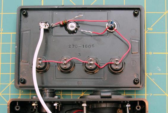 Connect the remaining lead on the LED, the remaining terminal on the firing switch, and the center terminals on the four paddle switches.