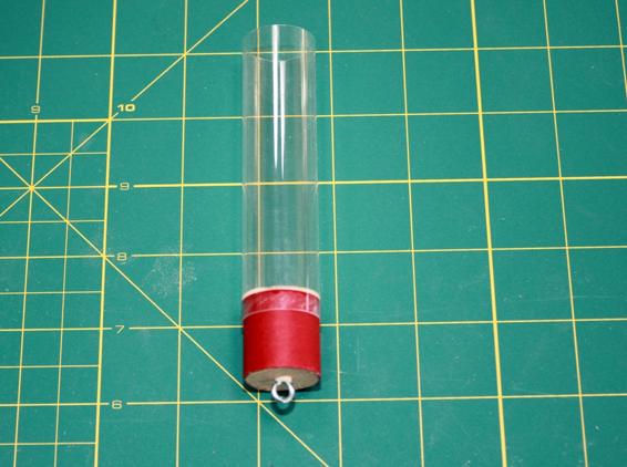 Glue the tube coupler into the payload tube and the screw eye into the bulkhead to complete the payload bay.