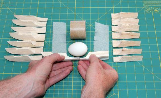 Carve the pieces so the egg, with padding, will fit in the cavity.