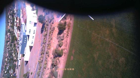 This frame from a flight movie shows a nearby middle school. The rocket is just tipping over. In a few more frames, the parachute pops out.