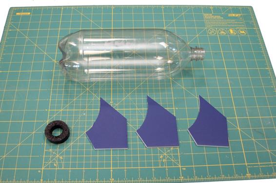 The parts for Themis include a two-liter bottle, three fins cut from foam core, and a nose pad cut from pipe insulation.