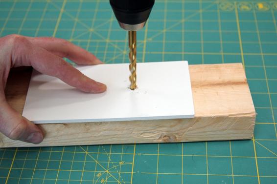 Use a piece of scrap wood under the foam core or soda bottle when drilling. This gives a stiffer back while drilling, resulting in a cleaner hole.