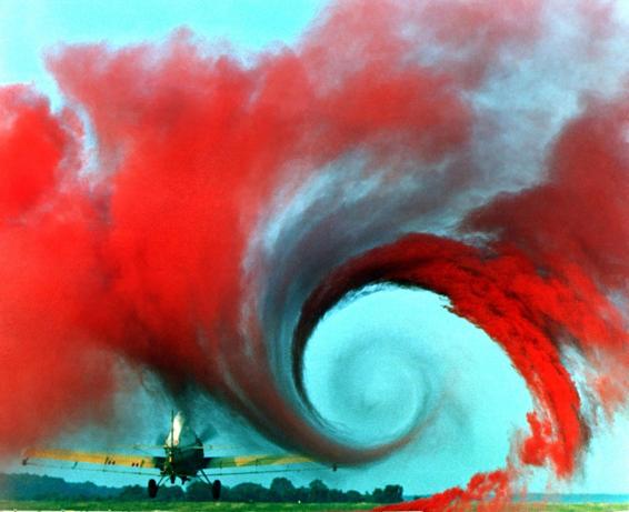 The vortex caused by induced drag is striking in this photo of a crop duster. The same thing happens on a rocket fin when it creates lift to straighten a rocket in flight.