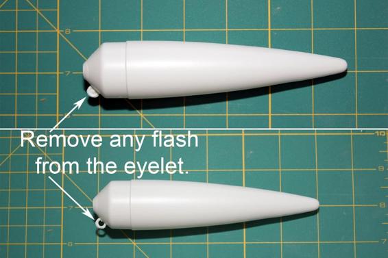 Remove any plastic blocking the eyelet, and scrape any excess plastic forming a line down the length of the nose cone.