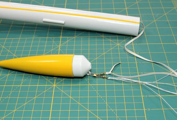 Attach the parachute and shock cord to the nose cone.