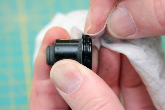 Use your fingernail to push the wipe into the thread grooves to clean them. Turn the closure as if you were screwing it in to move the wipe along the thread groove.