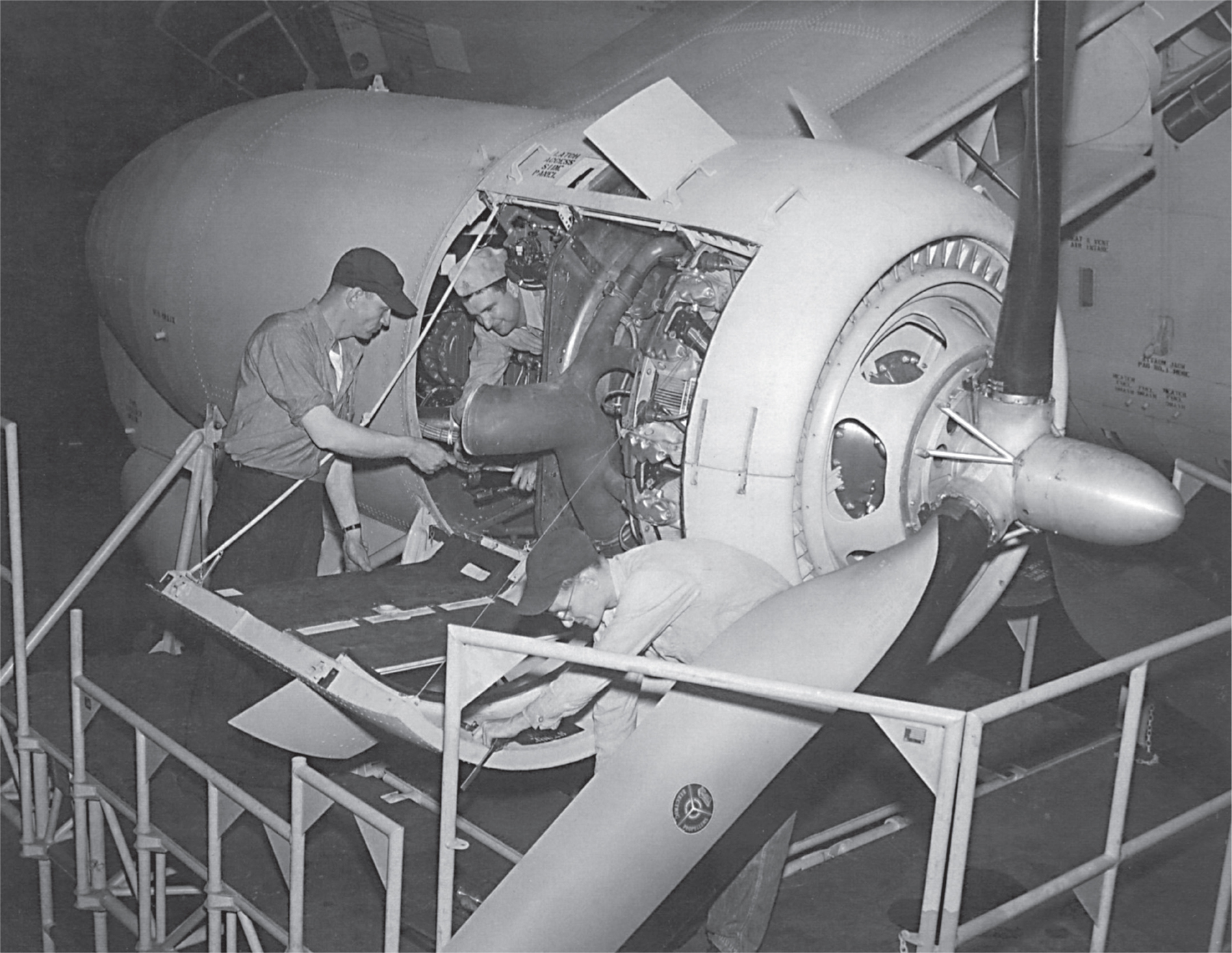 Navy mechanics inside engine...