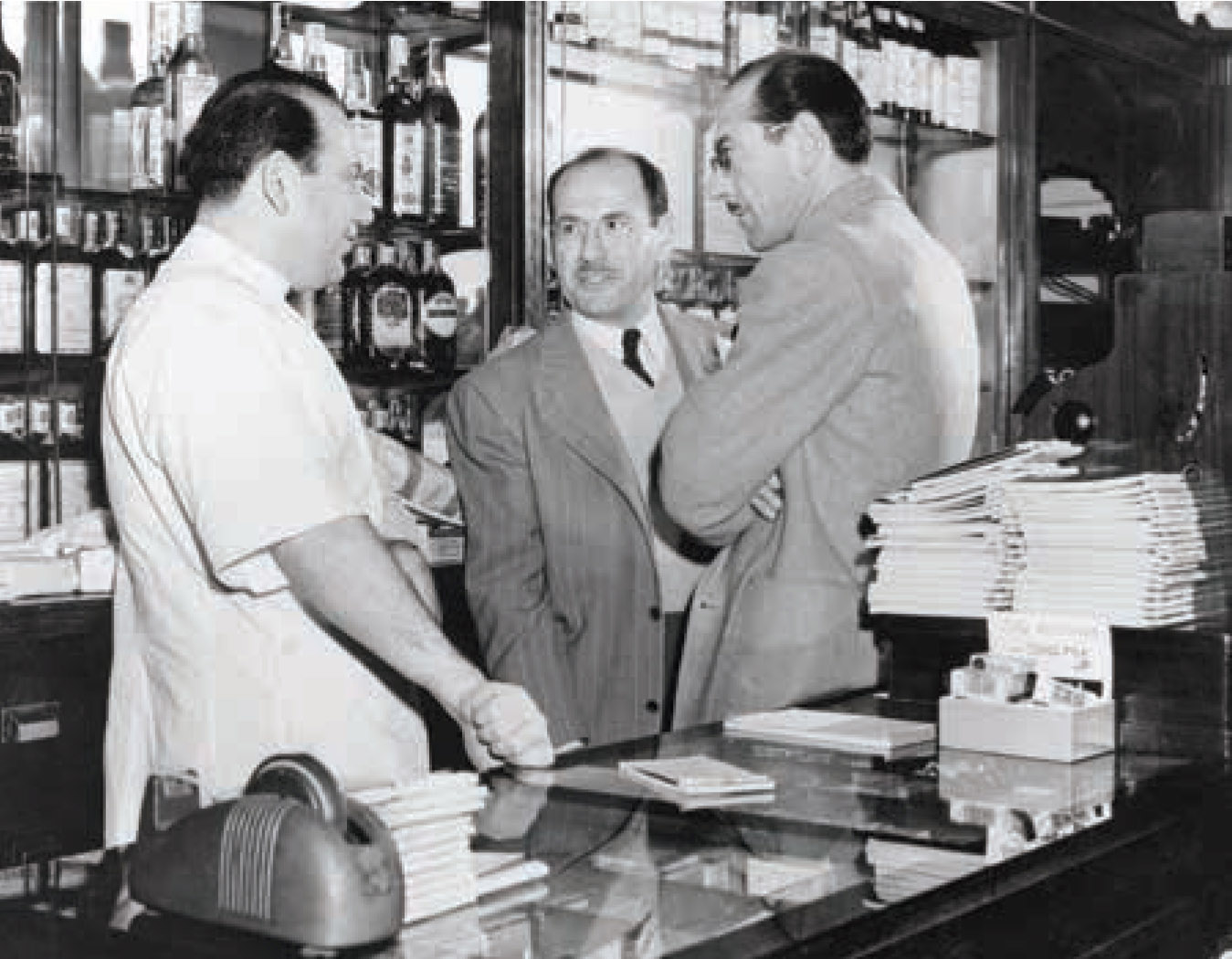 Leon, Jack, and Bernard Schwab behind the counter, 1948.