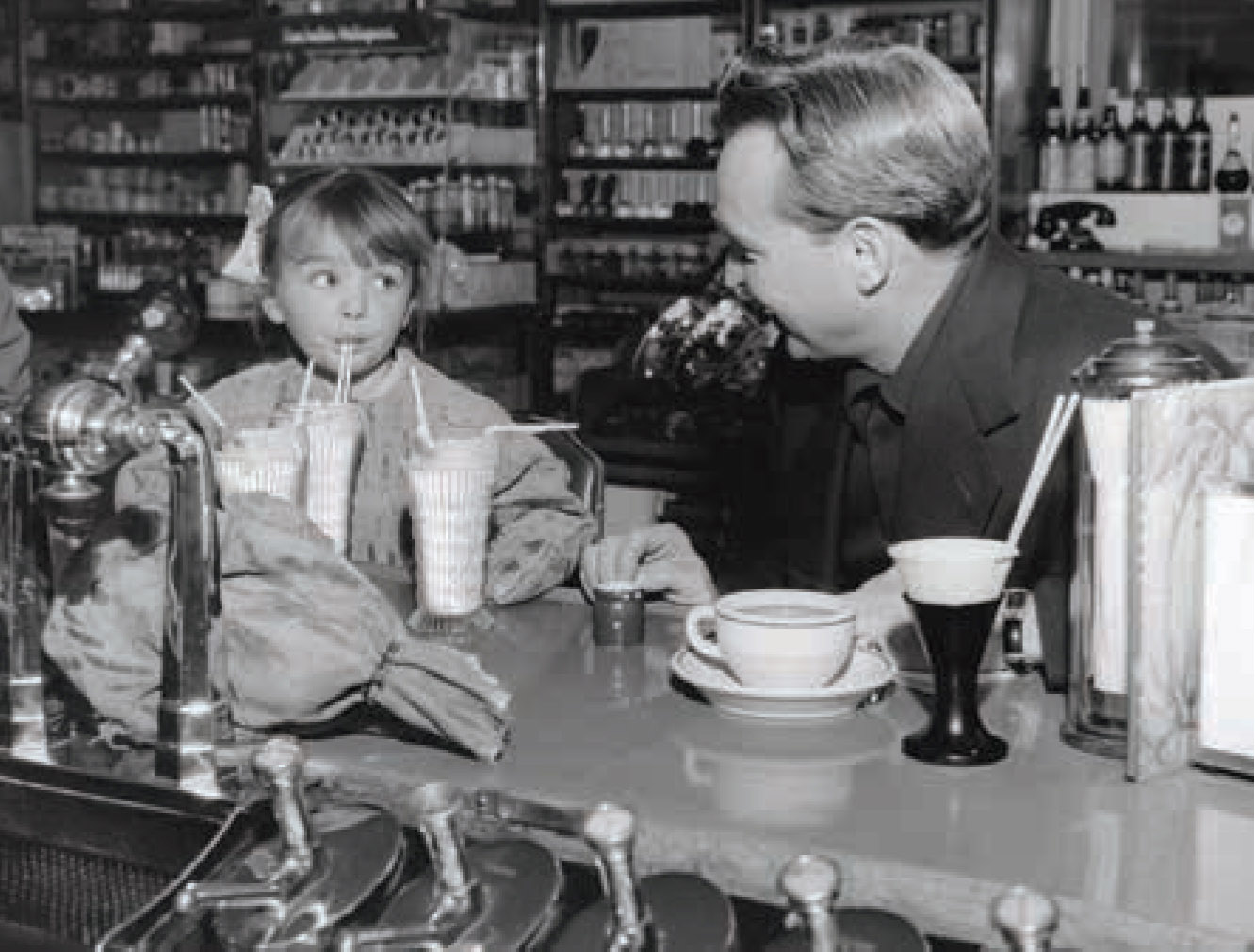 Customers enjoying desserts at the fountain counter, 1952.