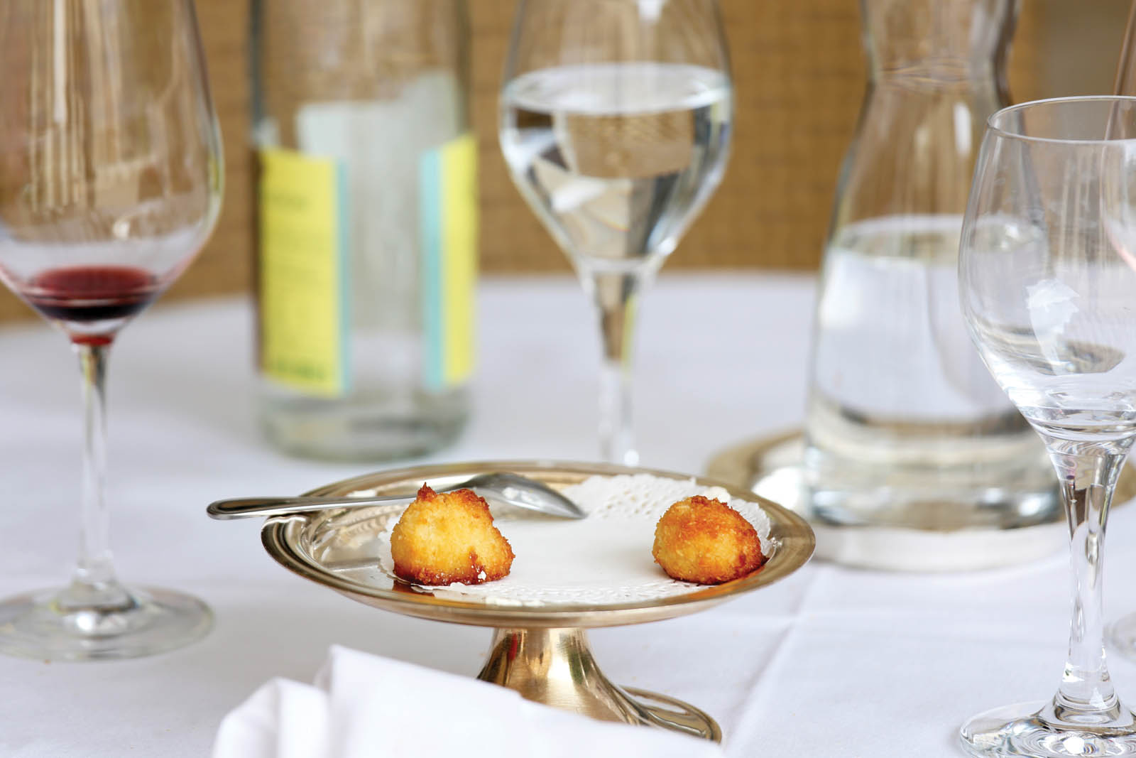 Photo of a table with wine glasses and a mostly empty dessert plate.