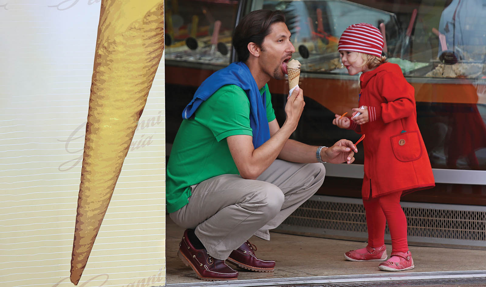 Photo of a man and child eating ice cream.