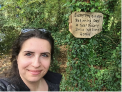 A person standing in front of a sign

Description automatically generated with low confidence