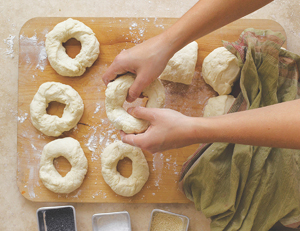 Shaping pieces of dough into small rings