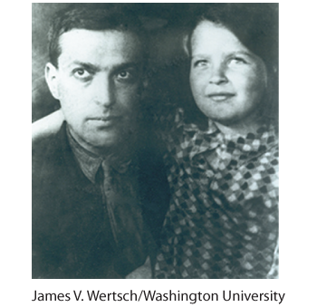 Black and white photograph of Lev Vygotsky pictured with his daughter in their younger days. He is wearing a suit and tie, and she is wearing a checkered dress.