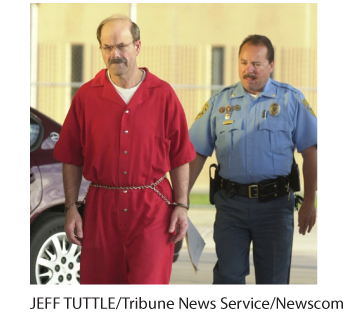 This is an image of a police officer escorting a shackled balding man in a red jumpsuit.