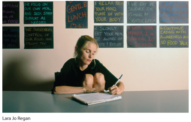 A photo of a woman writing her journal.