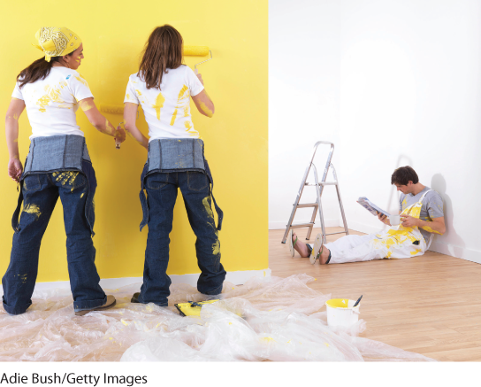 Photograph of three people responsible for painting a wall in a house.