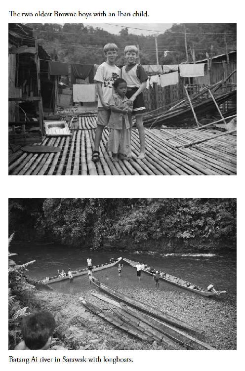 Two oldest Browne boys with Iban child, Batang Ai river with longboats 