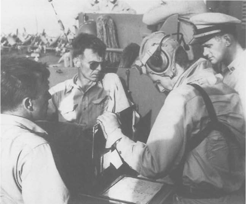 Aboard the Lexington Commander Ernest M. Snowden, Air Group 16’s skipper, reports about the unsuccessful search for the Japanese Fleet that was led by him. (U.S. Navy)