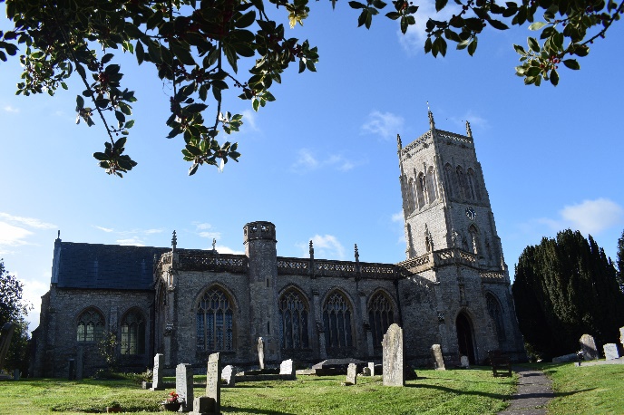 A large stone building with a clock tower Description automatically generated