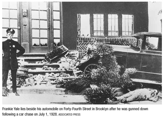 Frankie Yale lies beside his automobile on Forty-Fourth Street in Brooklyn after he was gunned down following a car chase on July 1, 1928. ASSOCIATED PRESS