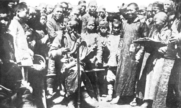 Crowd of people round a fortune teller