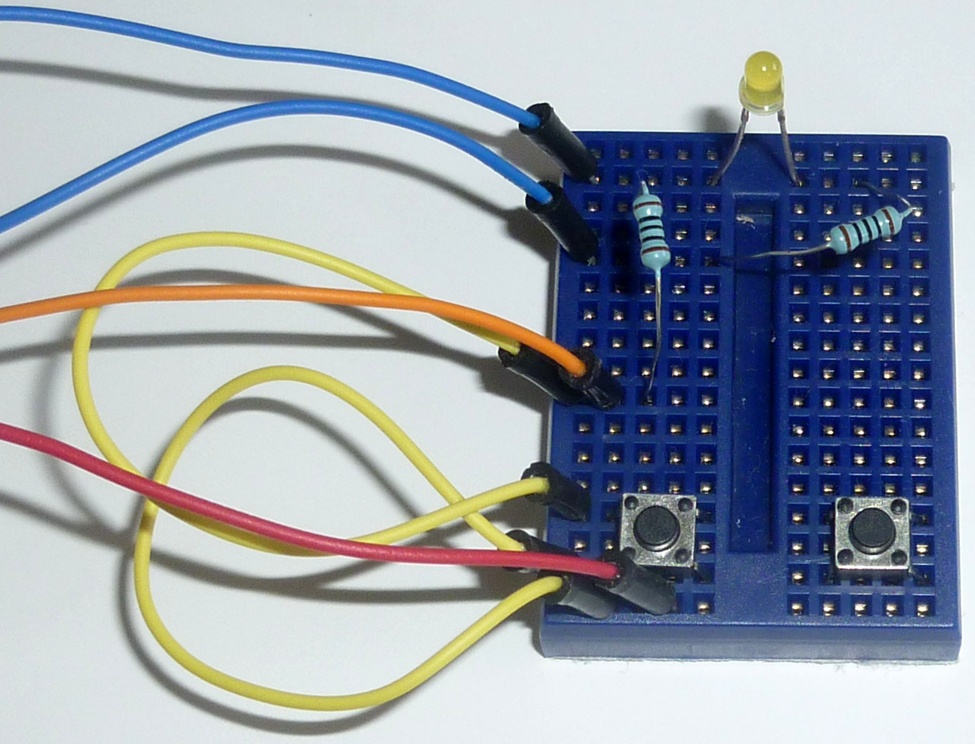 Insert the second pushbutton on the opposite side of the mini breadboard