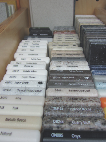 Photo image showing contemporary coloured hardwearing resin-based samples that can be machined to exact specification for worktops and sink-tops in kitchens and bathrooms. 