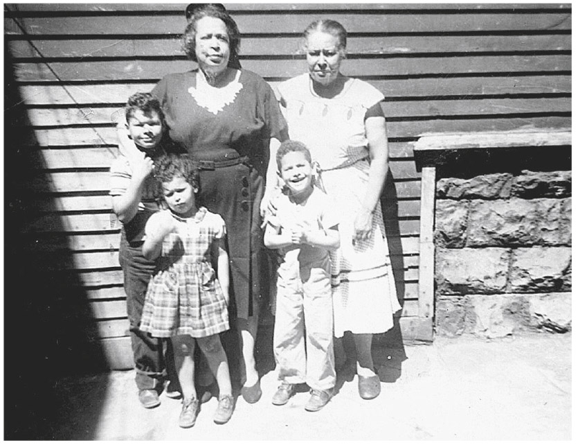 Illustration. Aunt Acie (left) and Grandma with my brothers and me. All of us were half white.