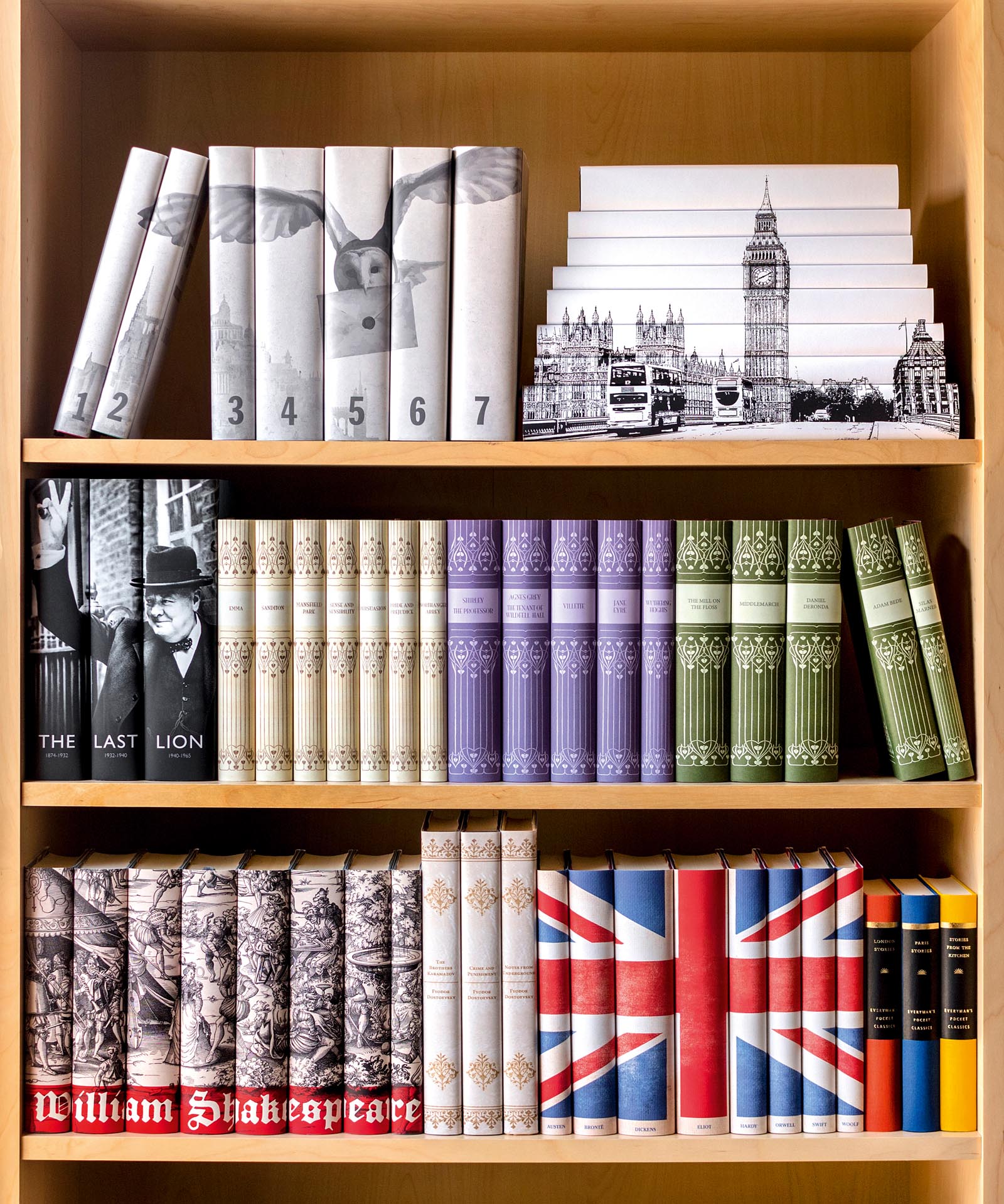 Photo of shelves stacked with books grouped with matching or image-adorned jackets.