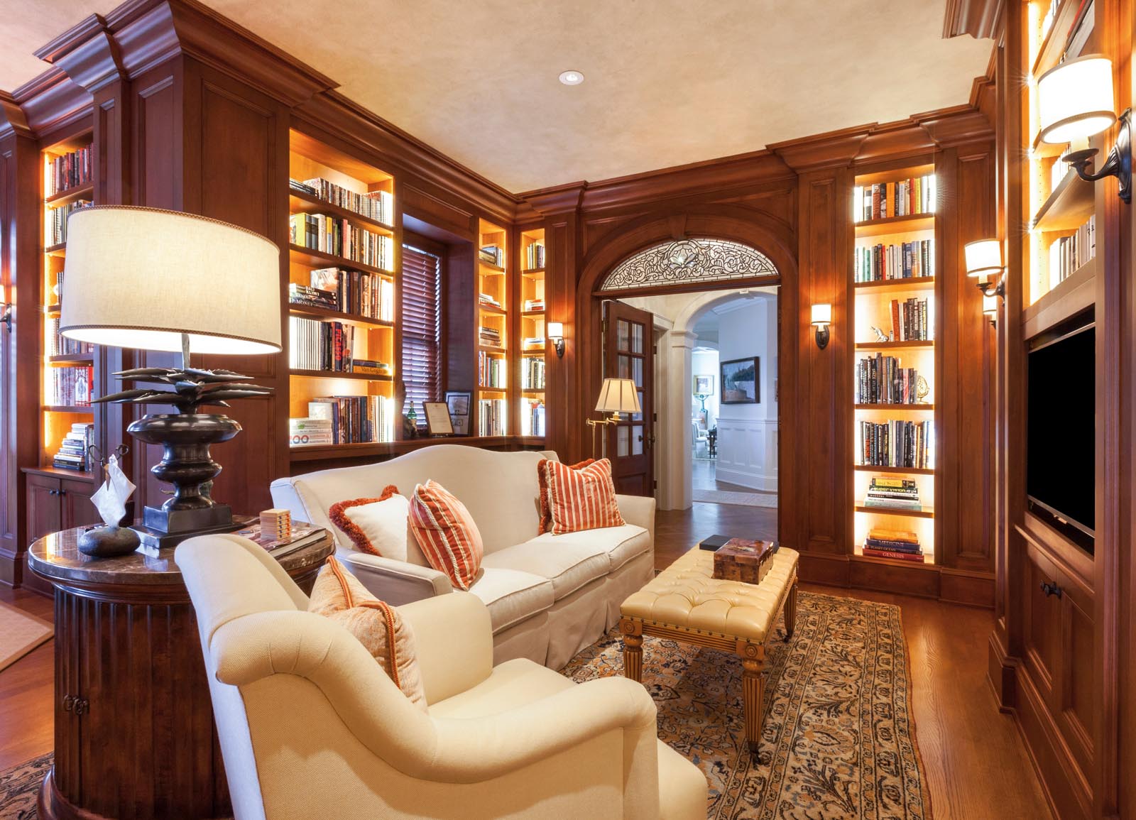 Photo of a library with lightes shelves along the walls.