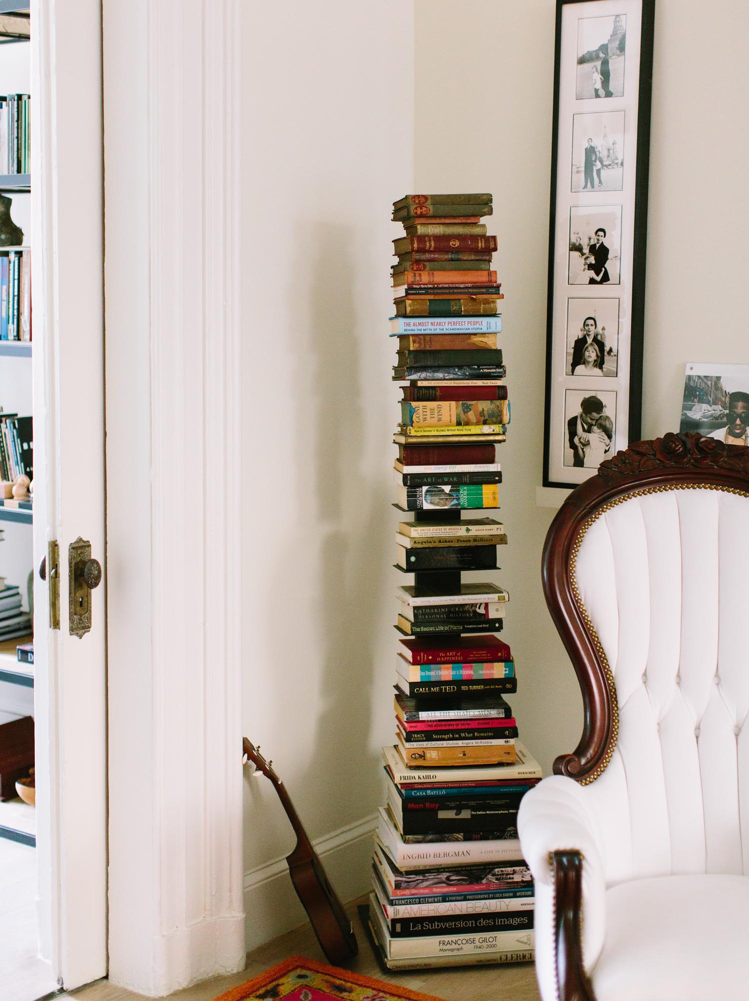 Photo of a subtle shelf in the corner turns a collection into a tower of books.