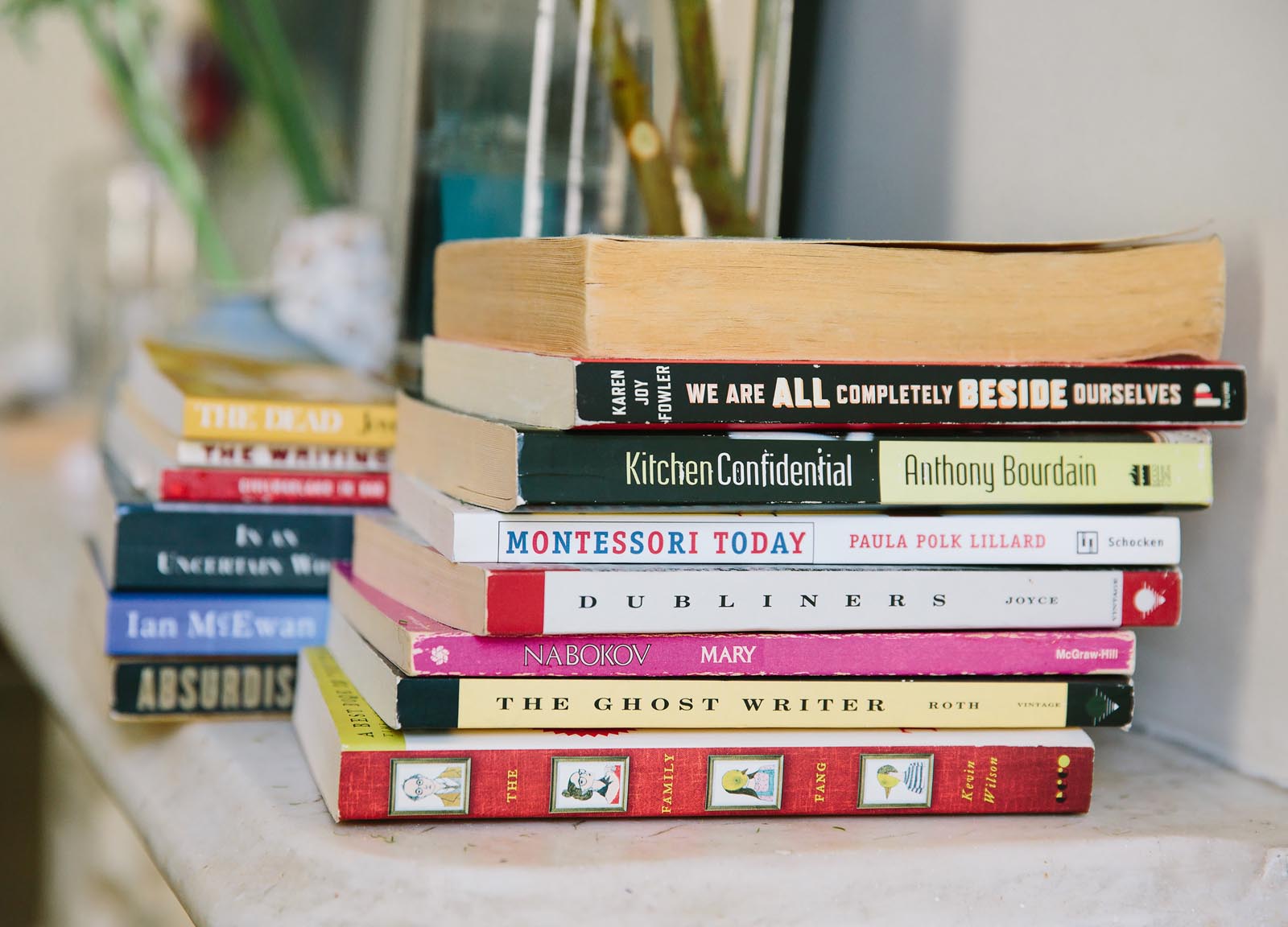 Photo of stacks of paperbacks on a mantle.