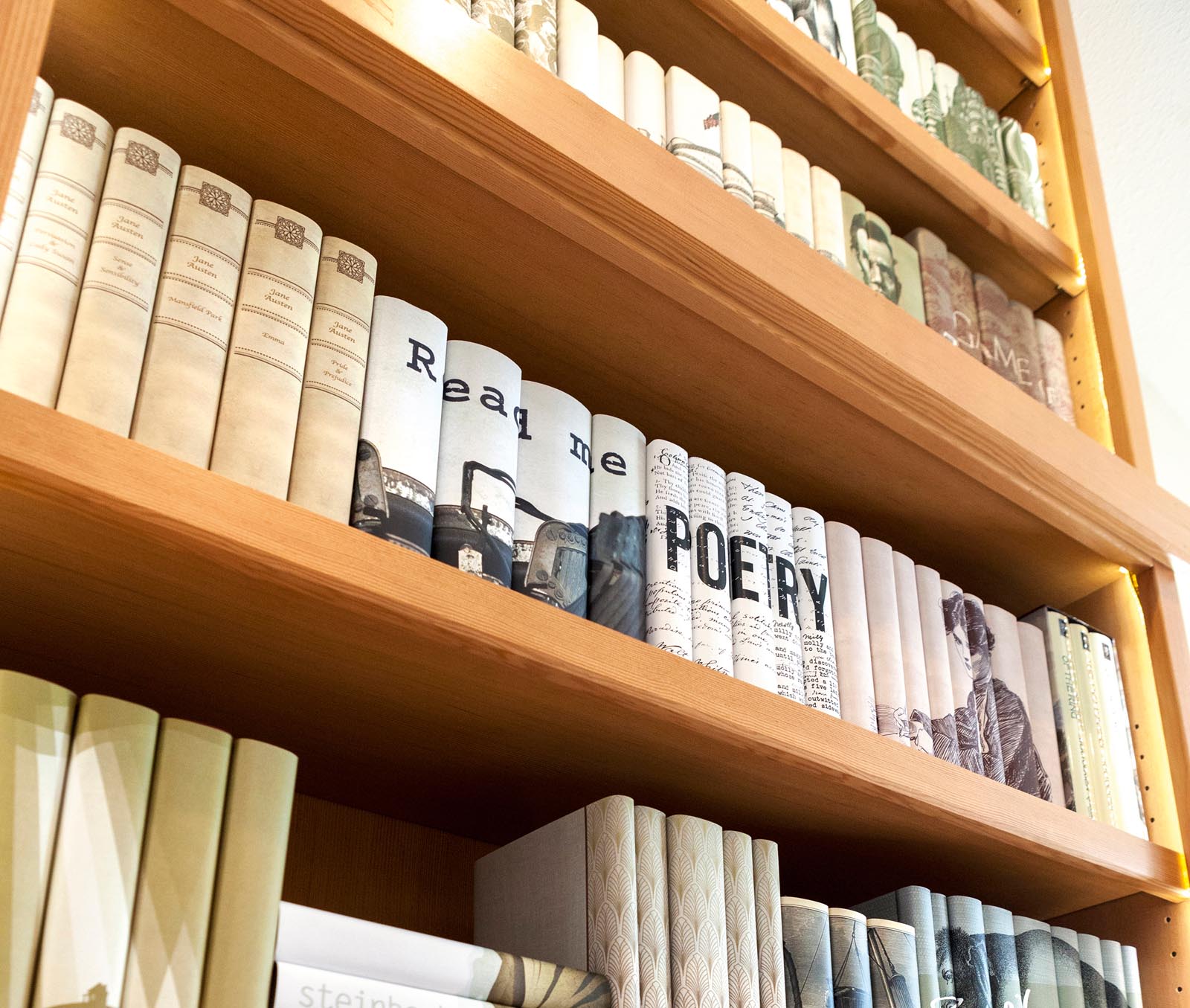 Photo of an angled view of shelves with neutral-colored book jackets.