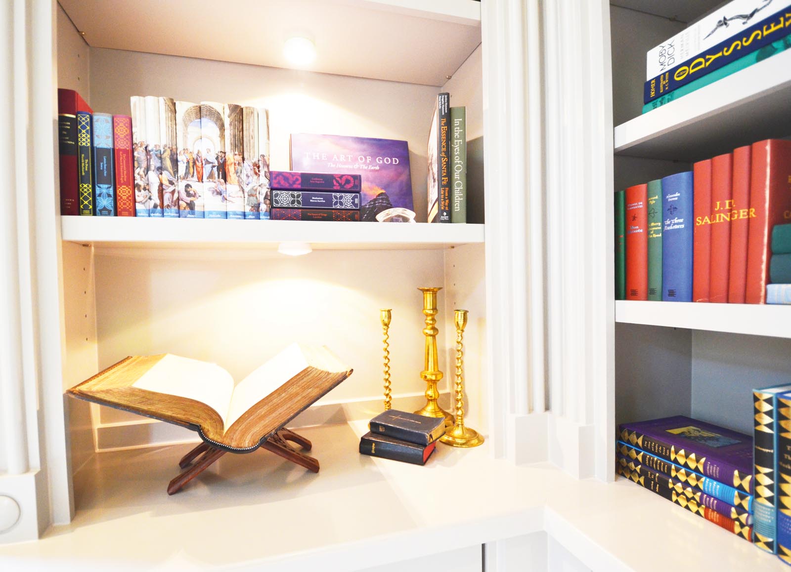 Photo of shelves highlighting a large religious volume.