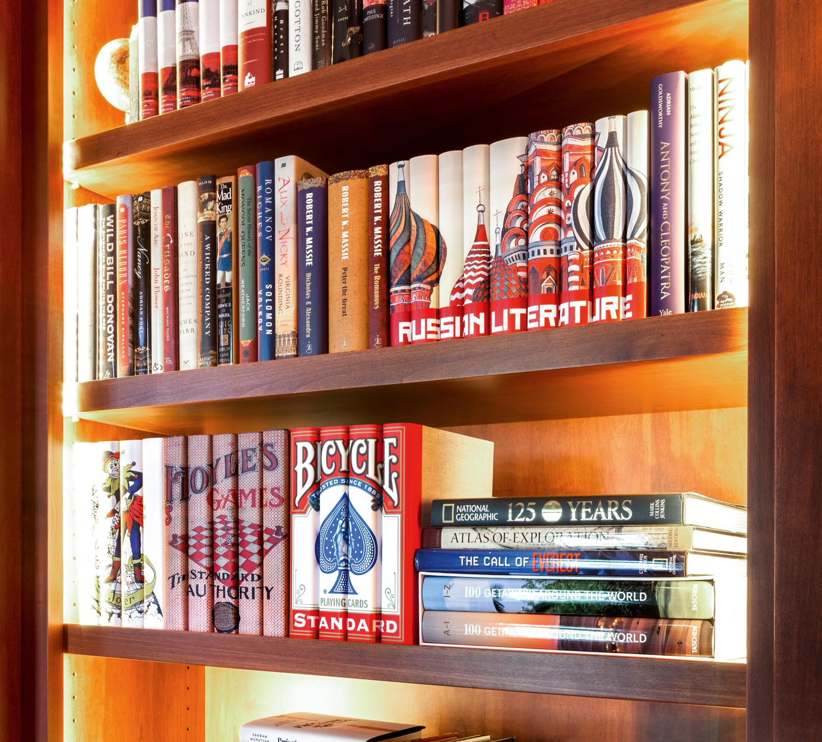 Photo of shelves of books, including some grouped with jacket spines that form an image together.