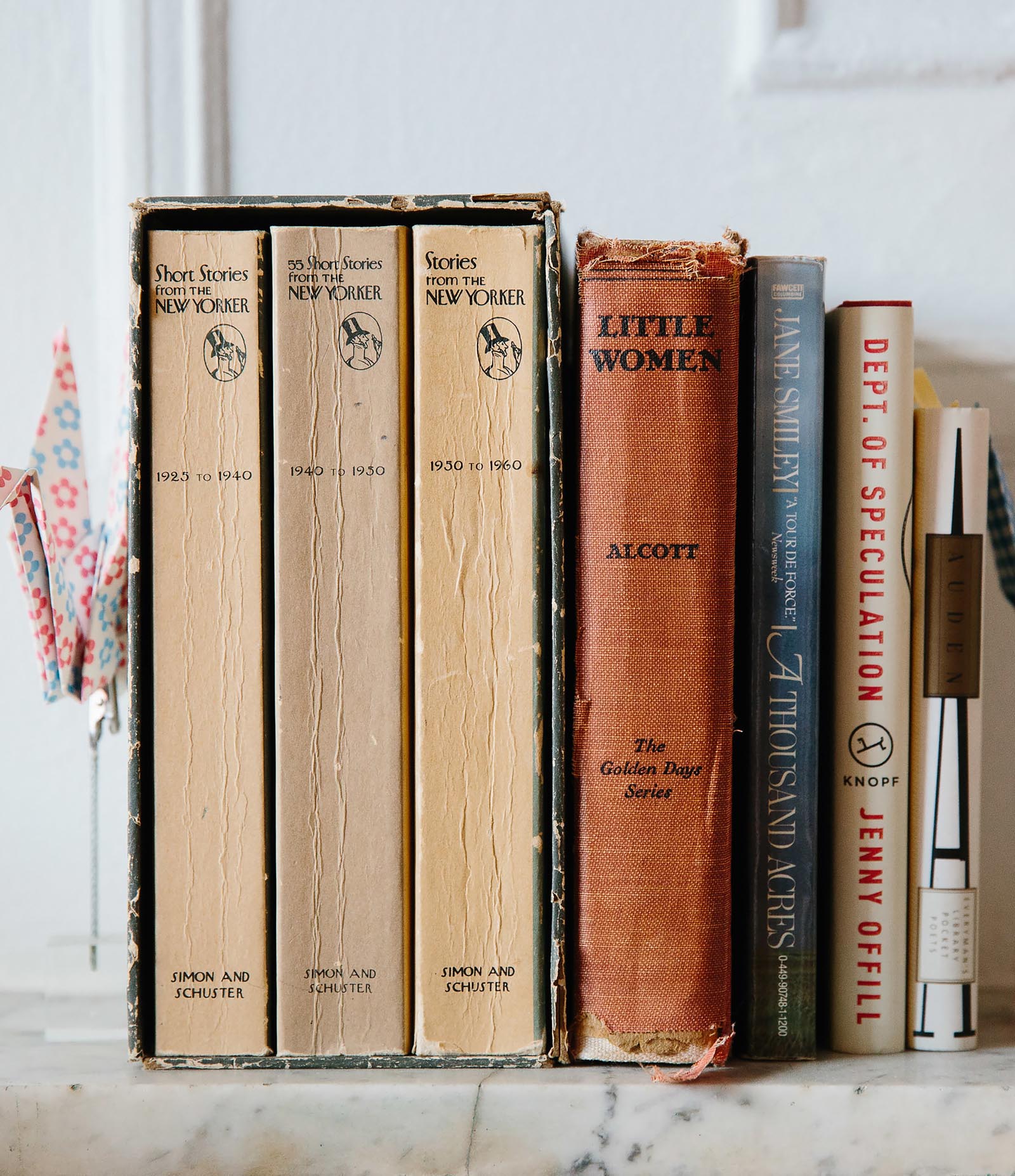 Photo of a group of books including a bowed set of stories from the New Yorker.