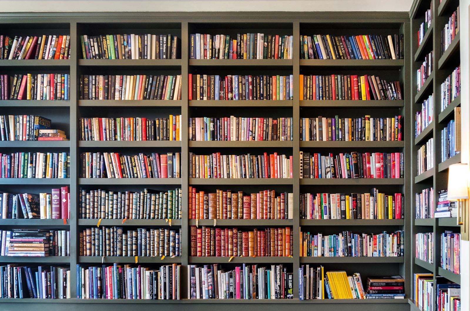 Photo of a wall of book-filled shelves.