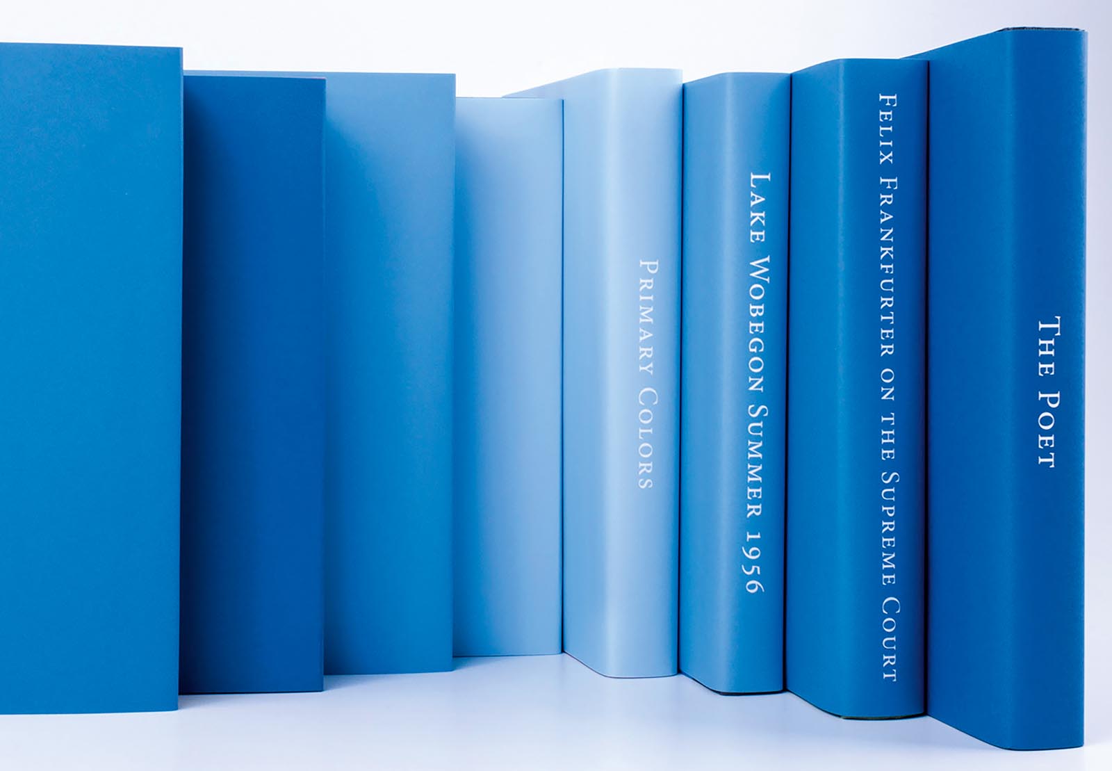 Photo of books jacketed in tones of blue.