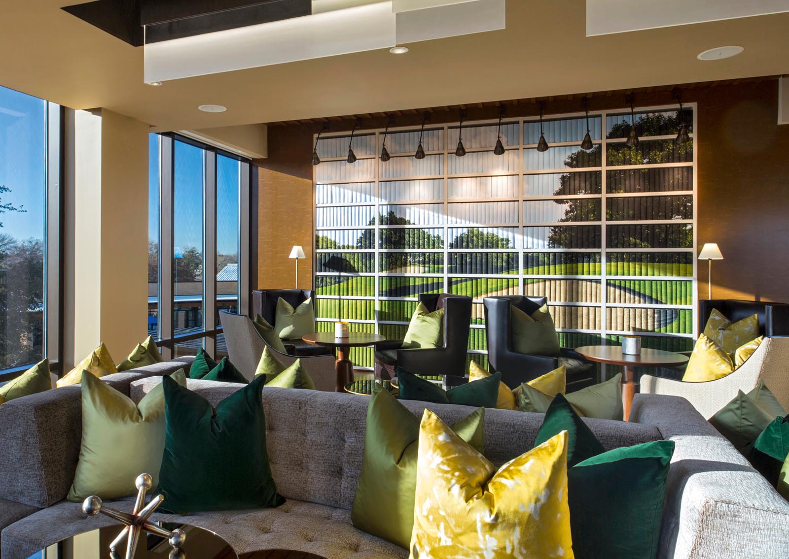 Photo of a lounge with a wall of books jacketed so that together they form a large image of a golf course.