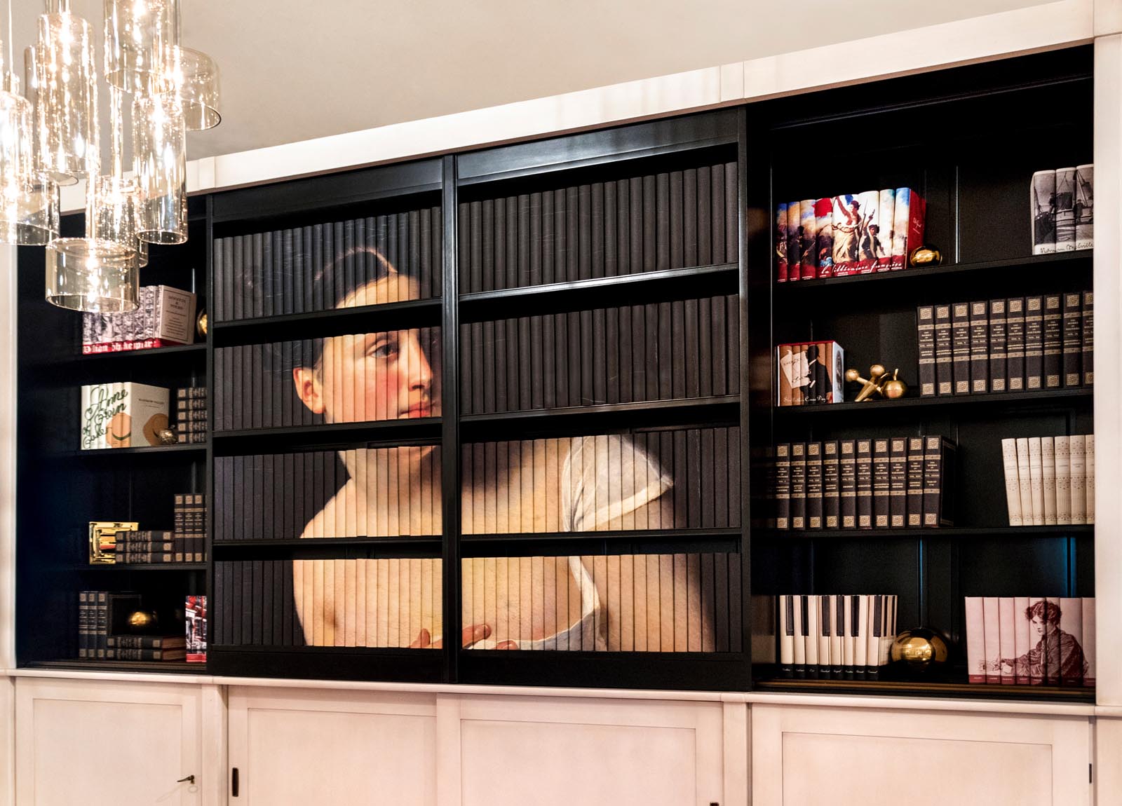 Photo of an elegant set of shelves with groups of books jacketed so their spines show historical images.