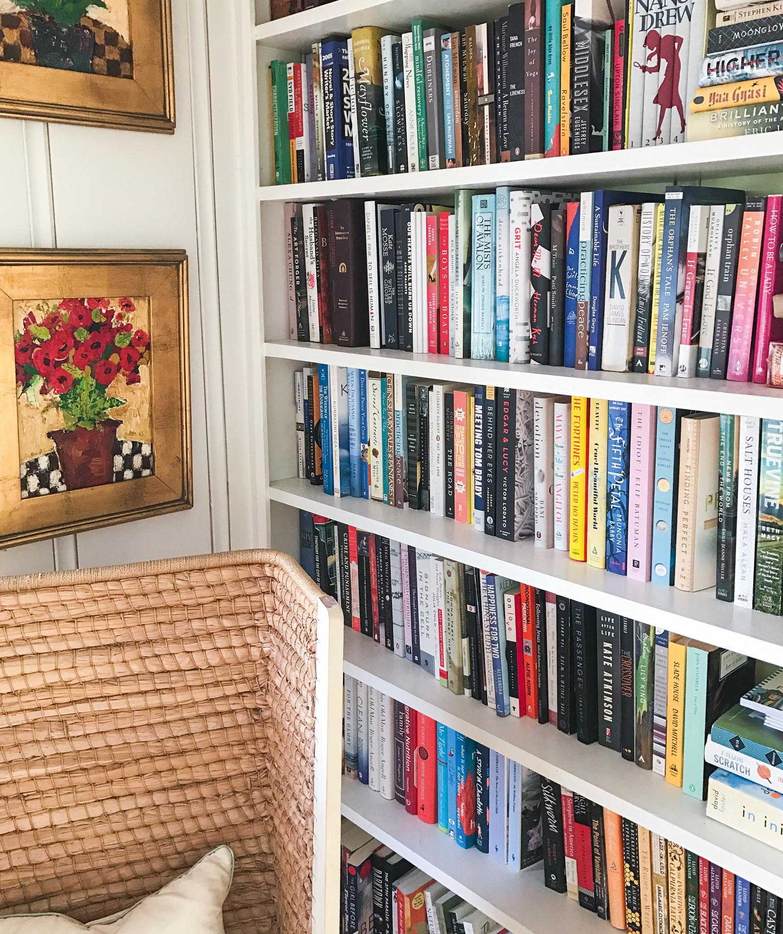 Photo of tall bookshelves filled with a variety of titles.