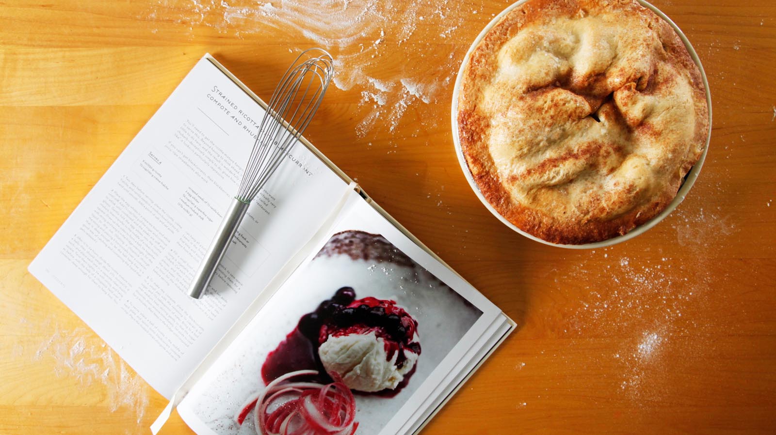 Photo of an open cookbook on a flour-spattered board.