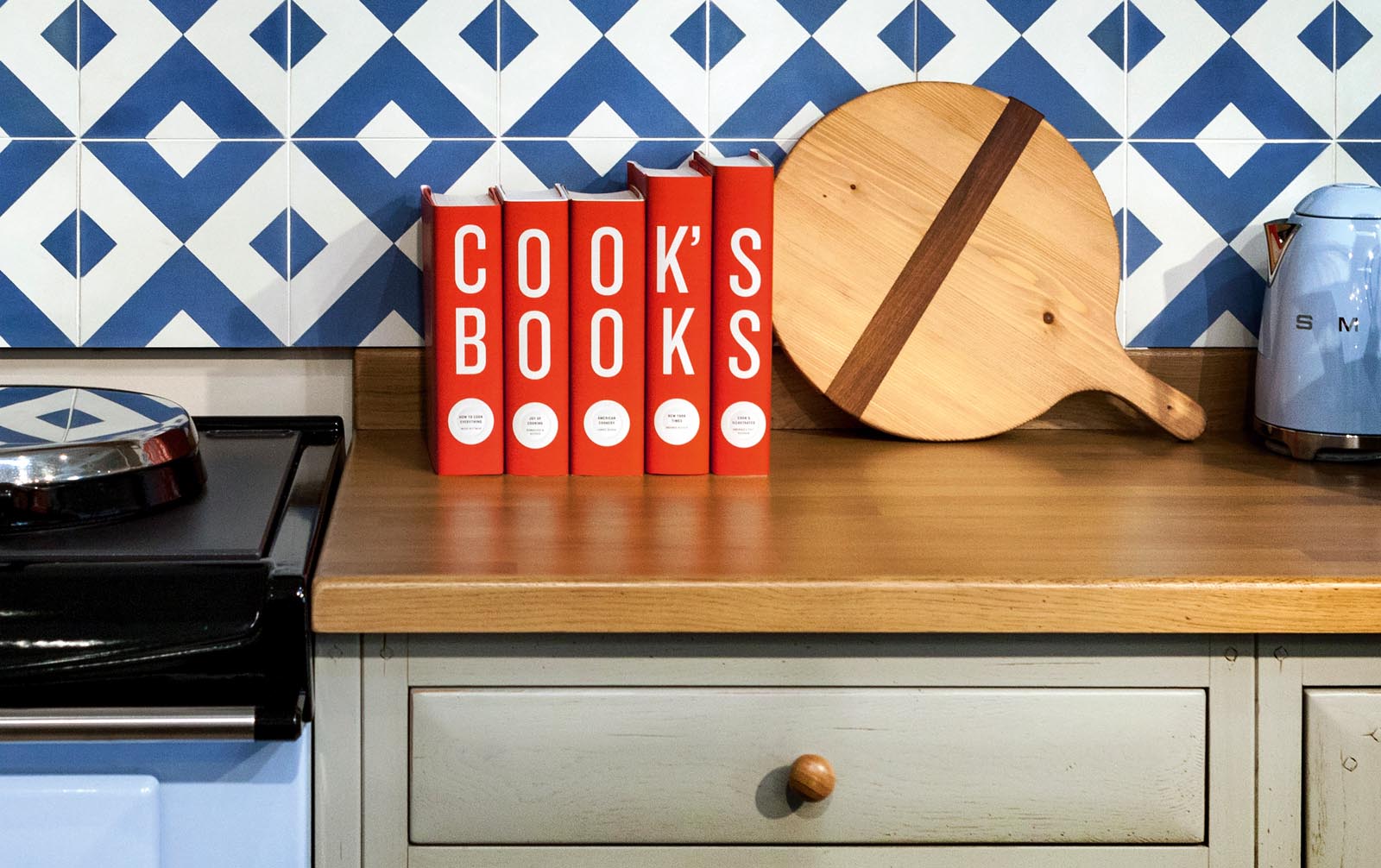 Photo of custom-jacketed books in the kitchen titled Cook's Books.