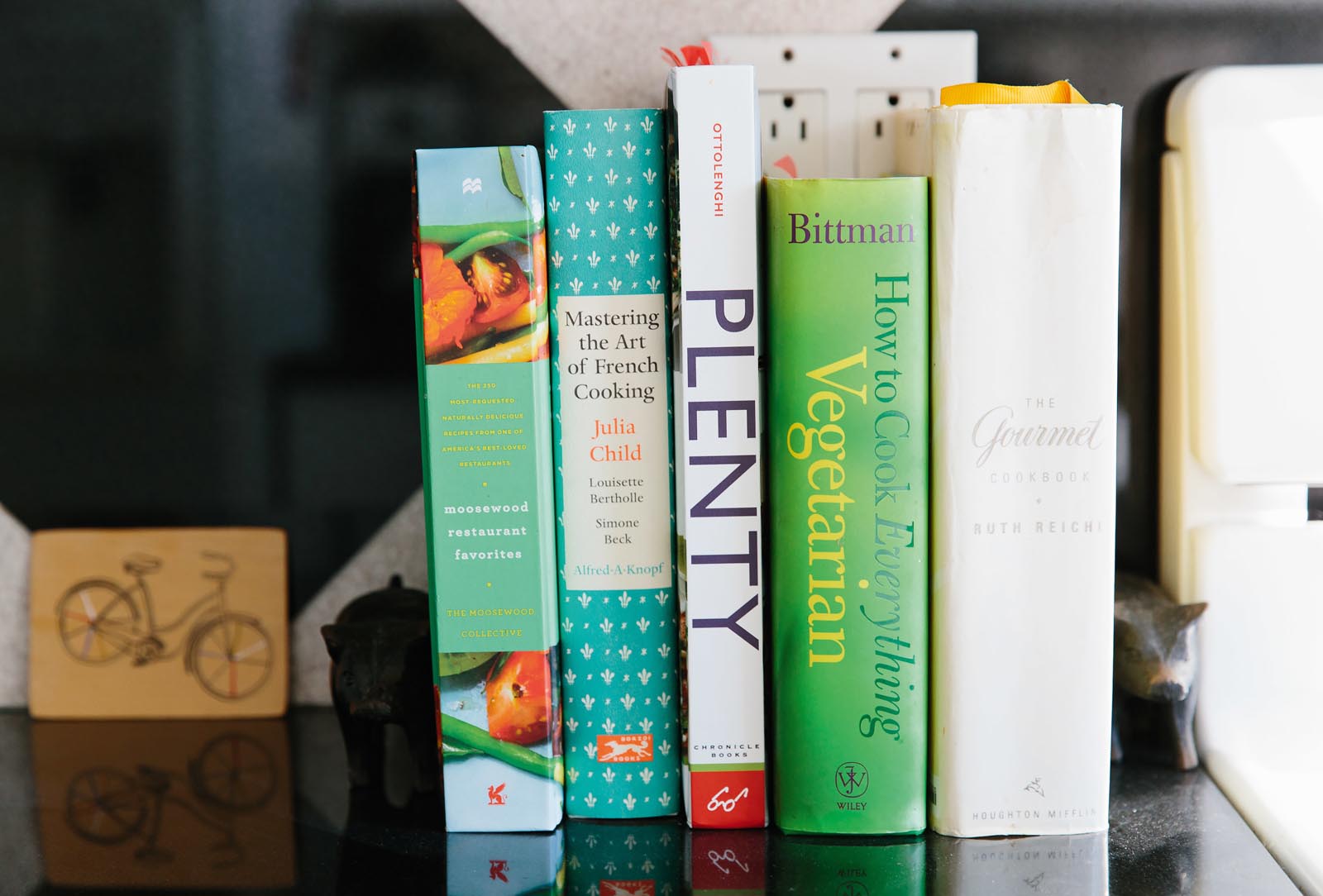 Photo of a group of cookbooks on a counter.