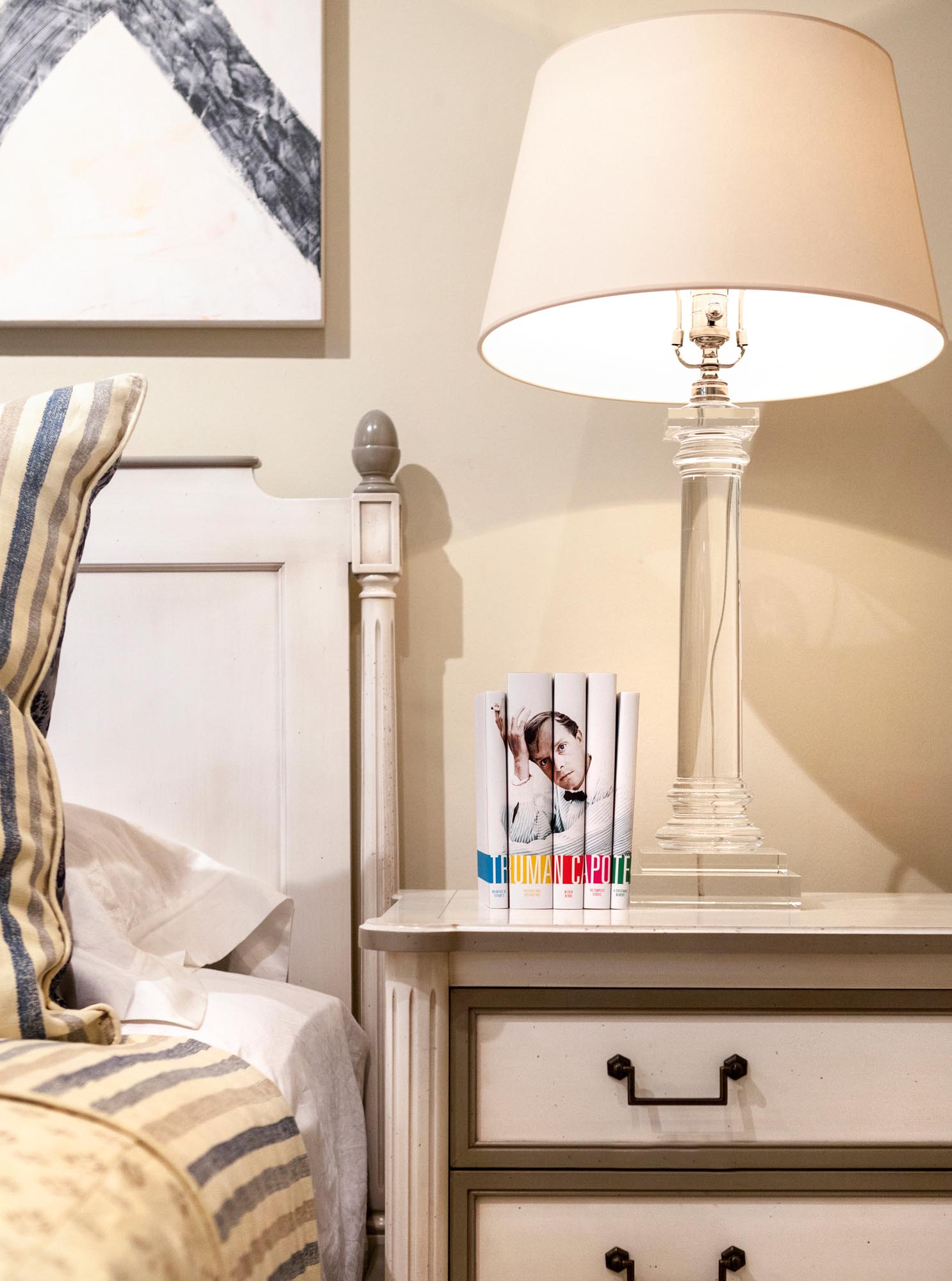 Photo of custom-jacketed Truman Capote books on bedside drawers.